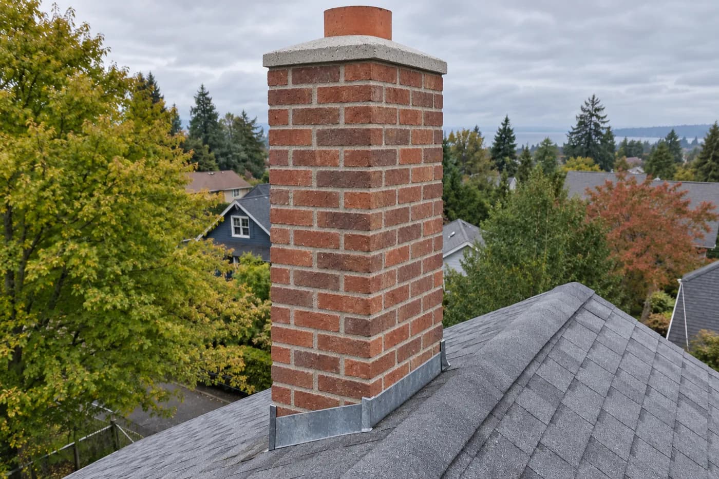 Roman brick chimney in Rainier Valley with spalled faces and a broken crown, before being rebuilt from the roofline up